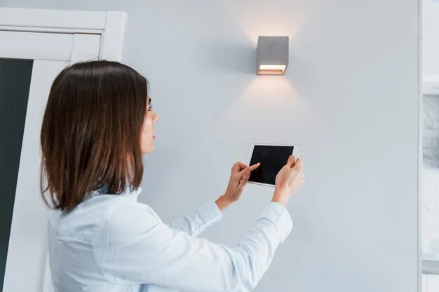 a woman using a tablet to control smart light in his home